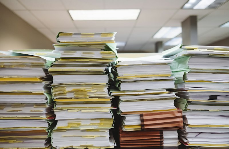 Pilhas de documentos e pastas de arquivo em um escritório